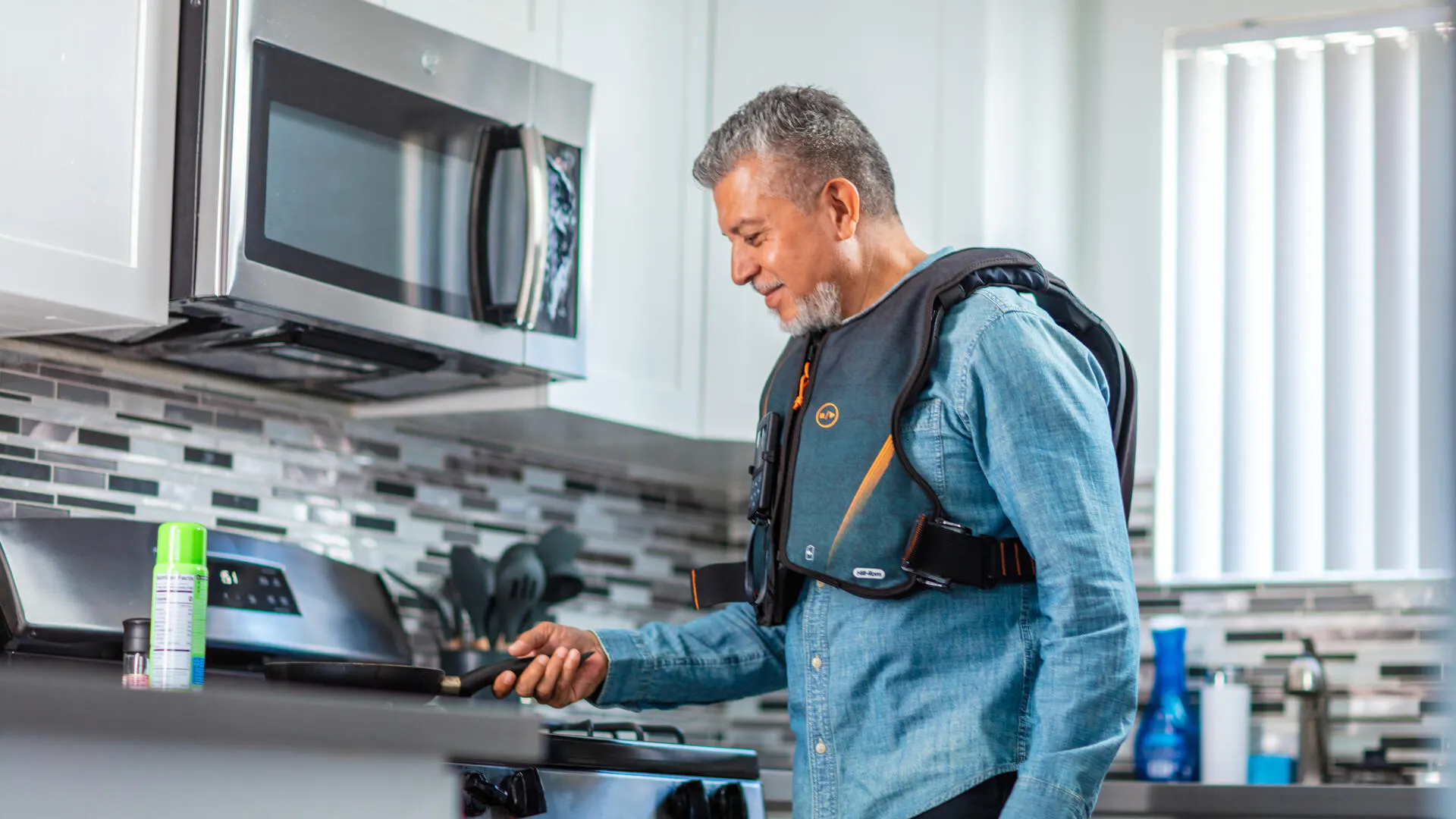 Man cooking at home while wearing the Monarch respiratory vest