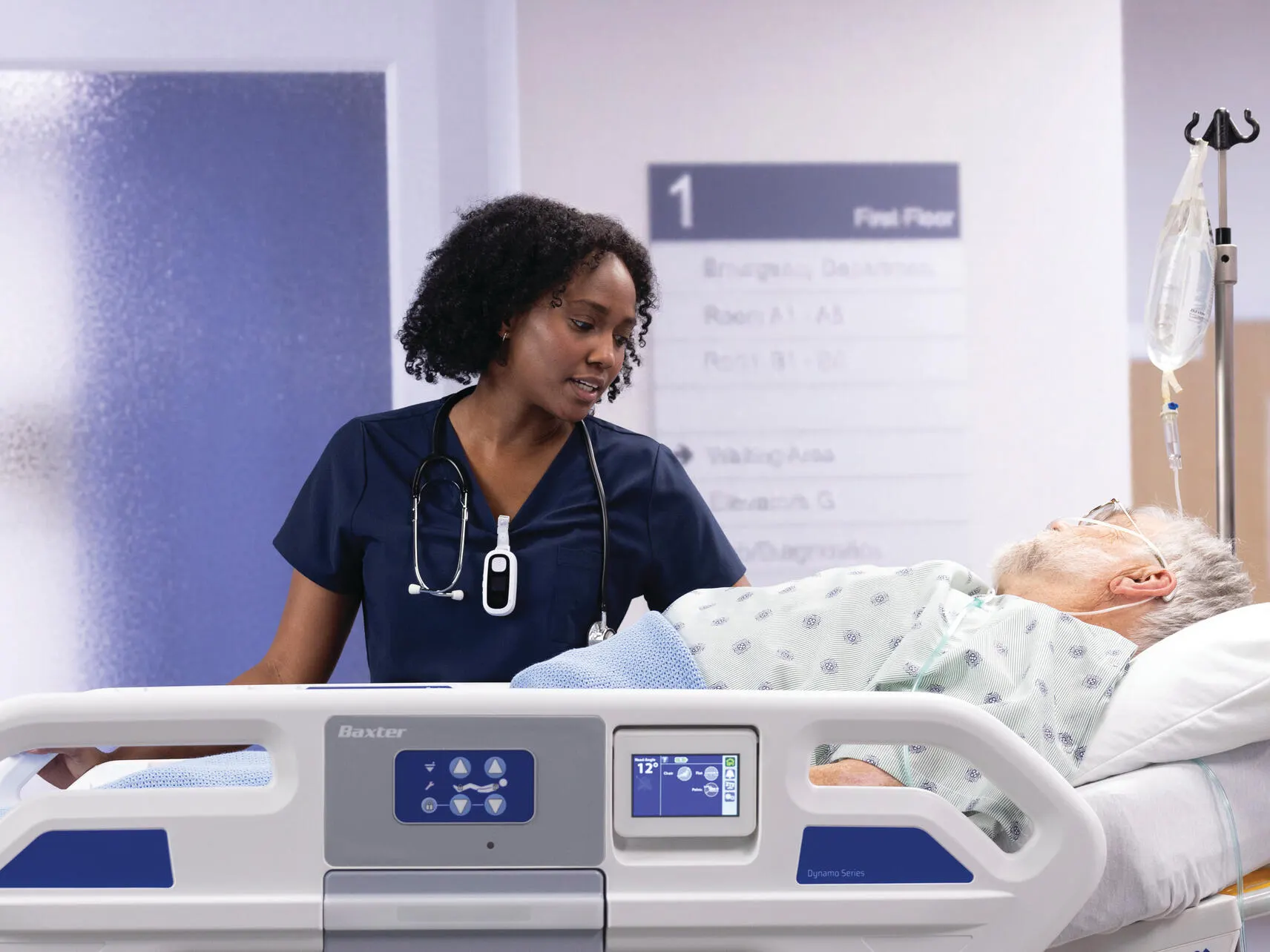 Healthcare profesional walking next to a patient who lies down on a Dynamo Strecher