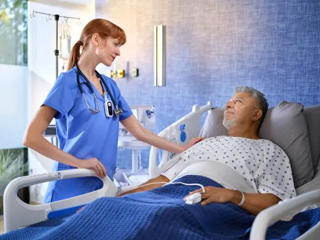 Nurse caring for patient in bed
