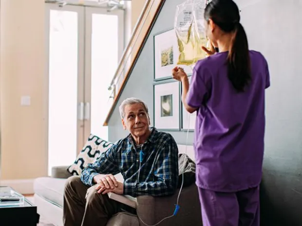 Healthcare worker helps a nutritional patient at home