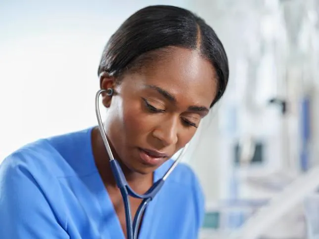 Clinician Examines a Patient with a Stethoscope