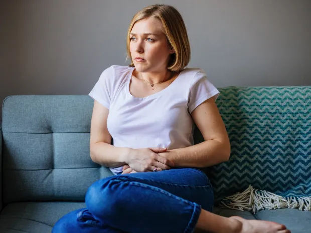Woman holding her stomach in pain