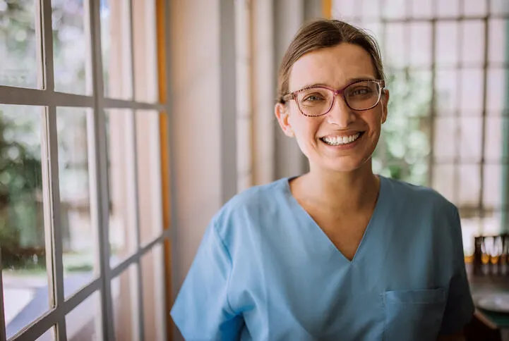 A healthcare worker smiling at the camera