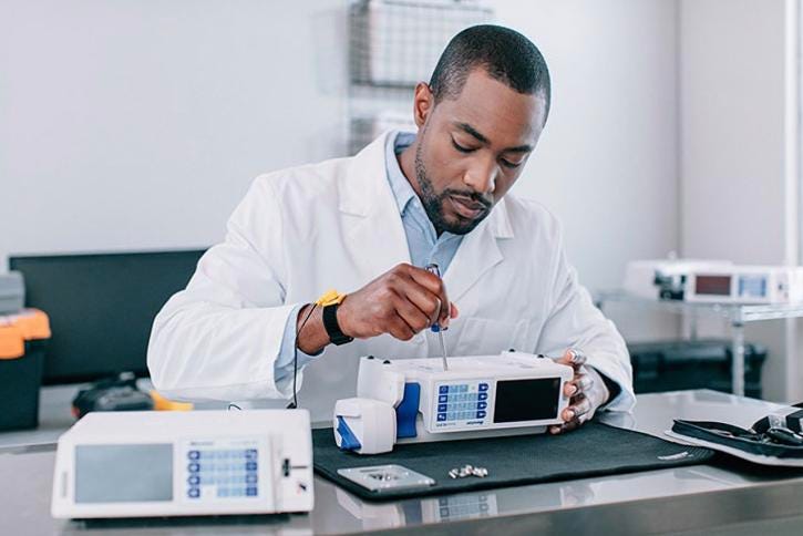 Service tech repairing an infusion pump