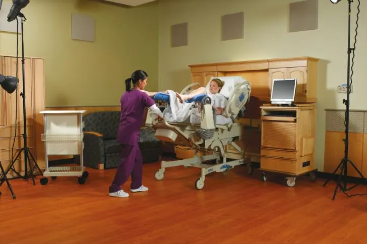 Patients in birthing stirrups being assisted by a healthcare professional