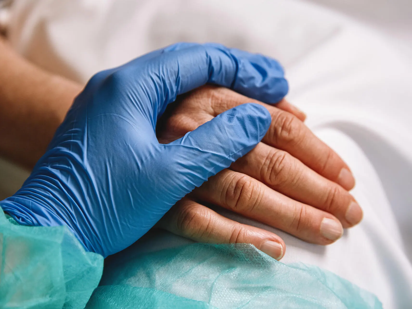Doctor holding patient hand