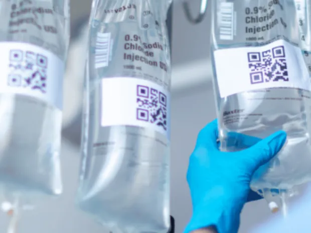Baxter IV solution bags being handled by a healthcare profesional