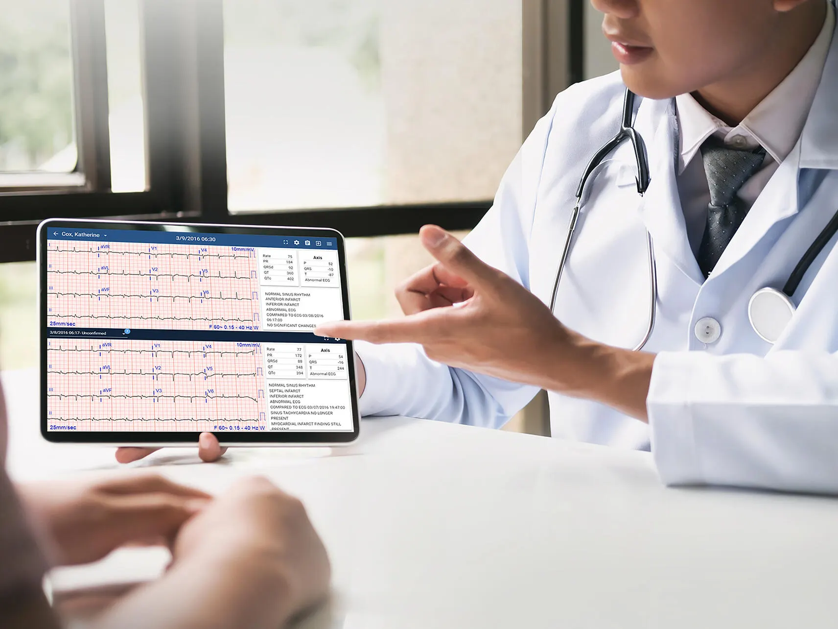 Clinician shows patient an ECG readout on a tablet