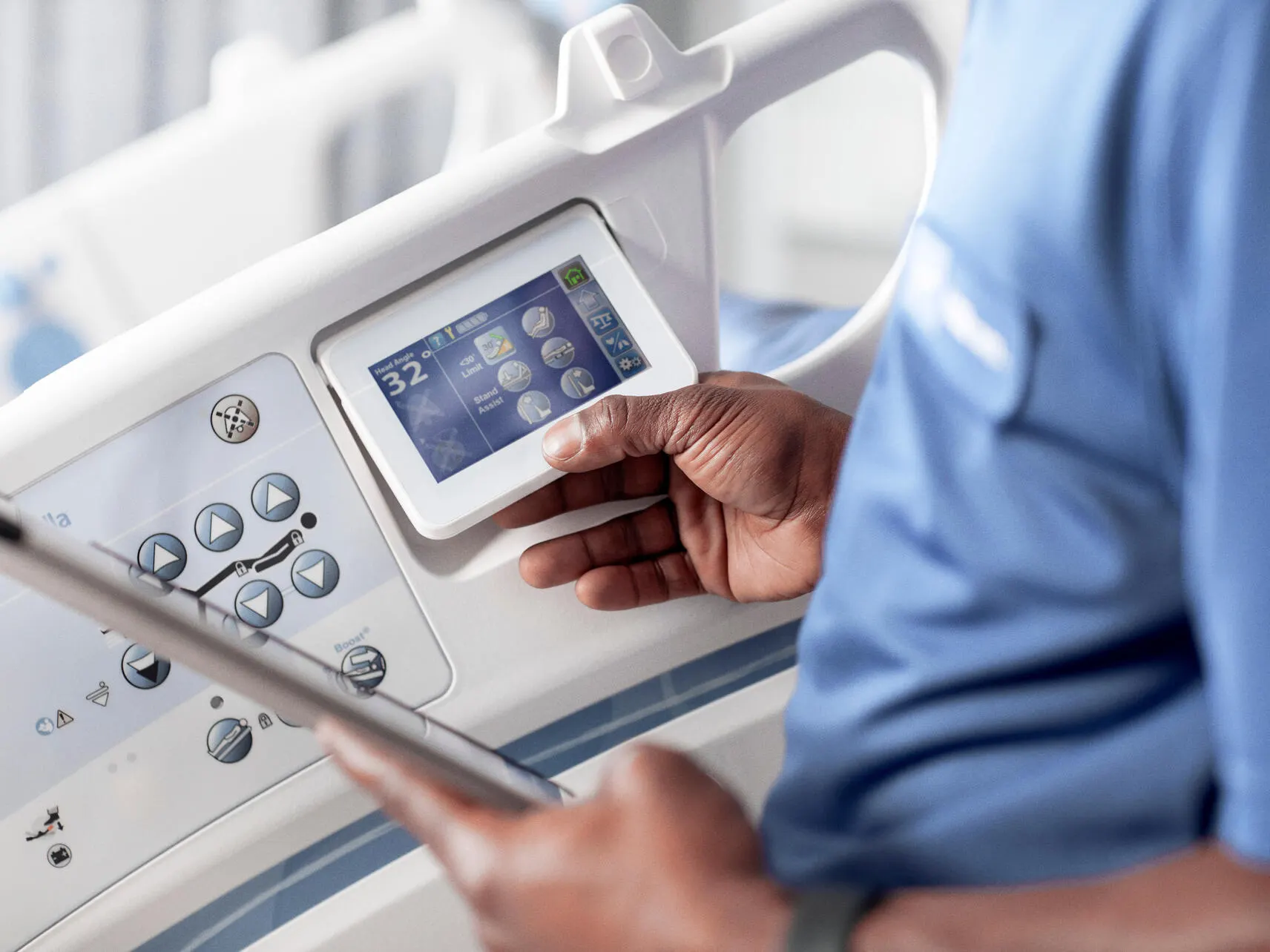 A healthcare worker inspects a hospital bed