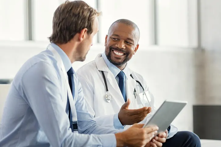 A businessperson and physician have a discussion