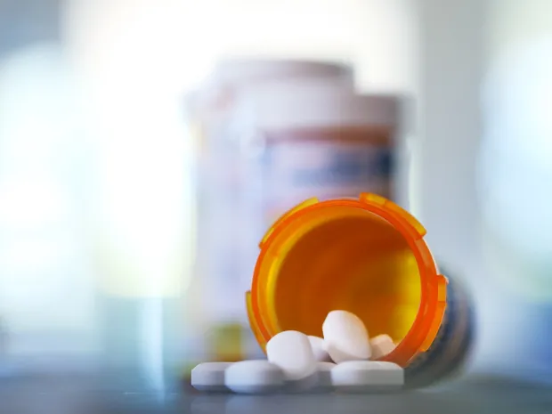 Pills spilling out of a pill bottle