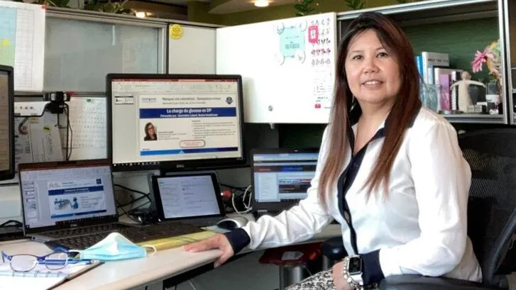 Ruby Calpito poses at her desk