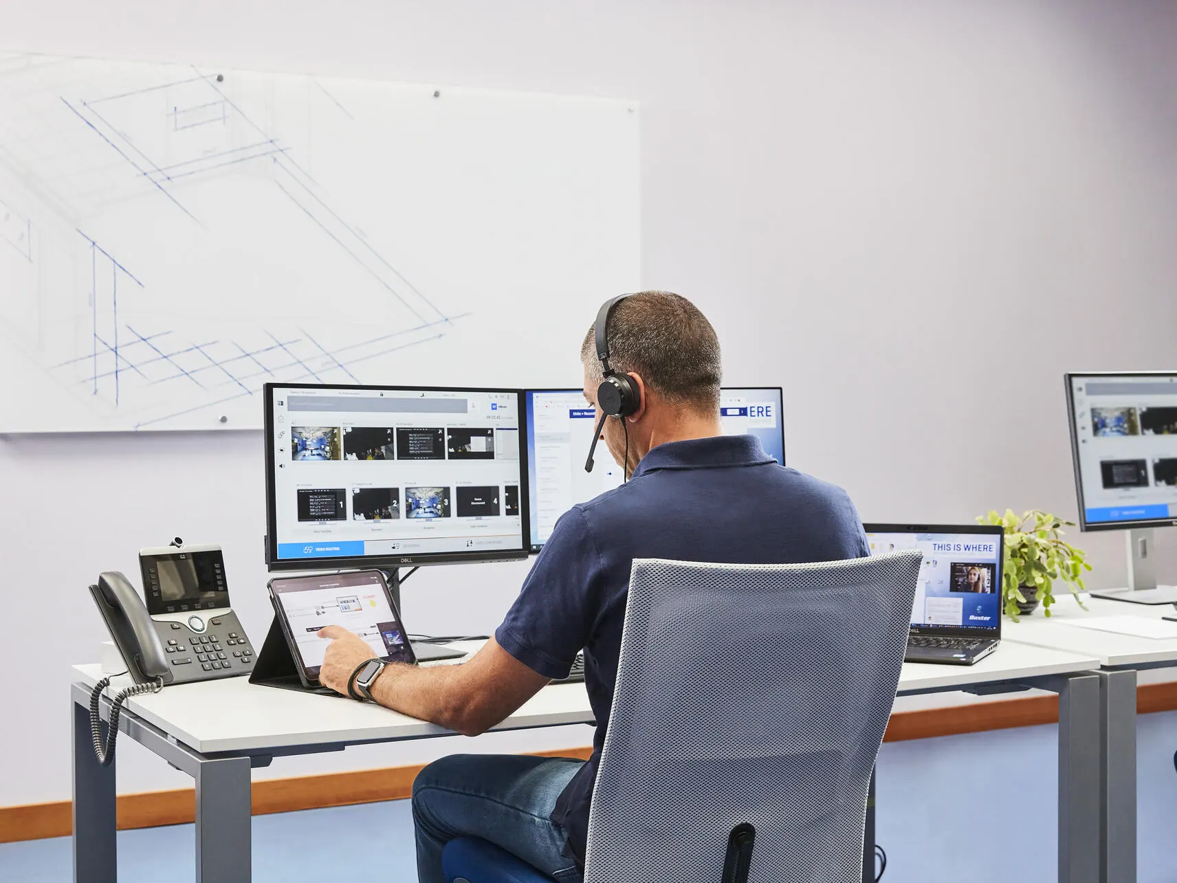 A Baxter support technician provides remote assistance via their computer
