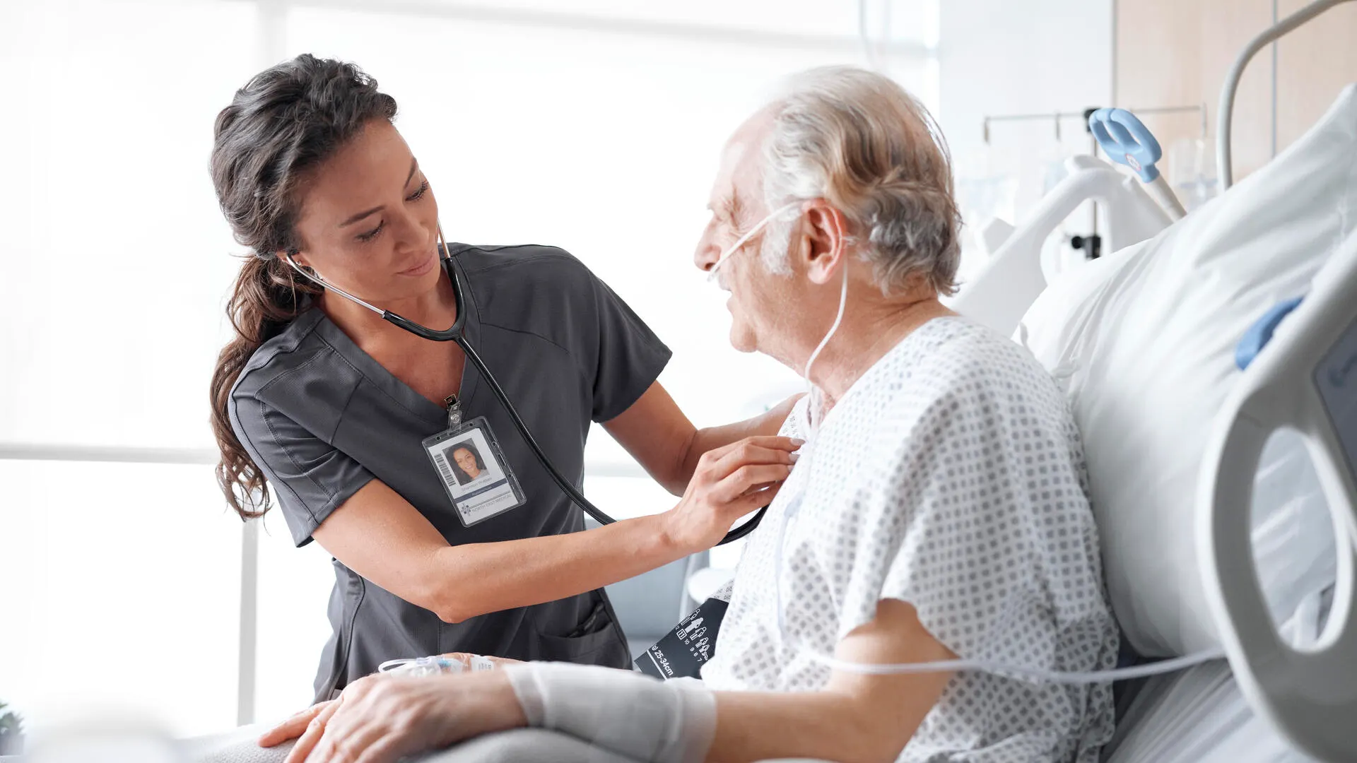 Caregiver assisting a patient in bed