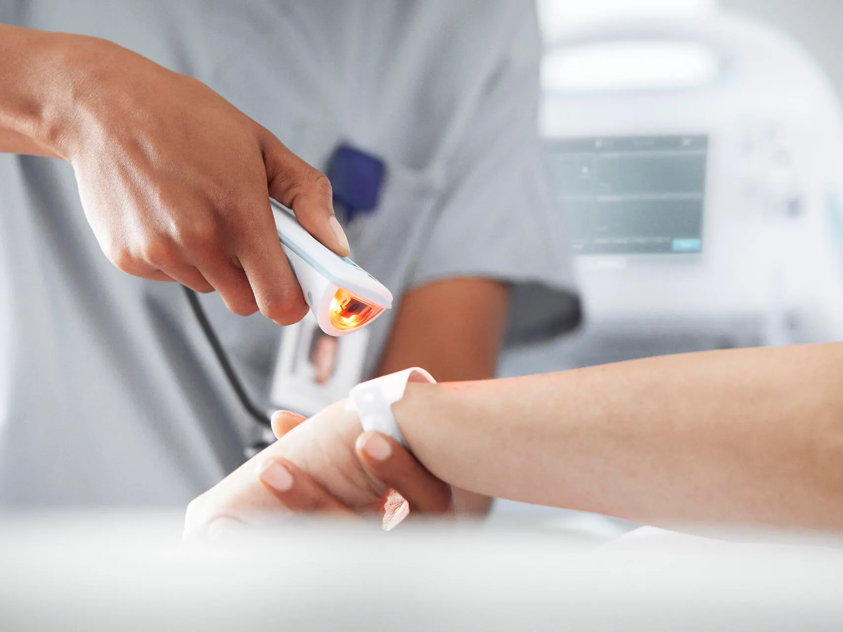 Healthcare worker scans barcode on a patient's medical wristband
