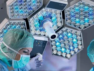 A surgical team member repositions an iLED 5 Surgical Light.