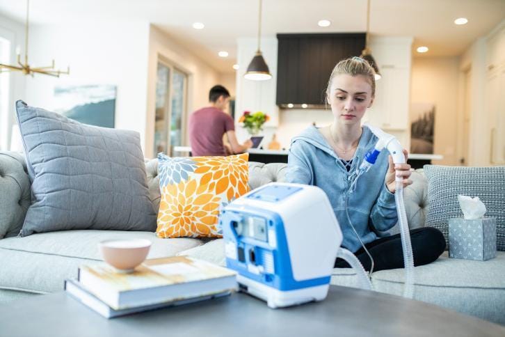 Young woman using VOLARA system in home setting