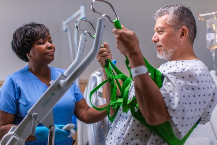 Patient using Baxter lift to assist in safe patient mobility
