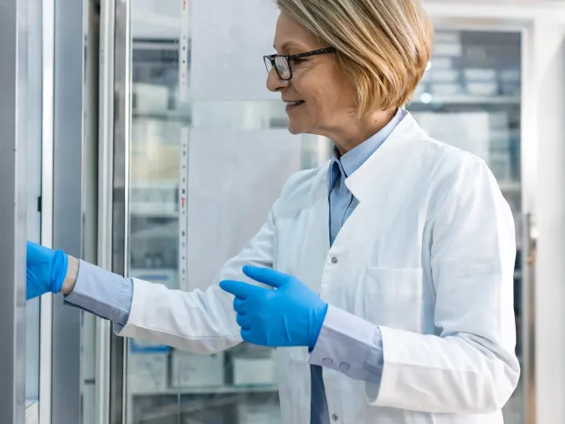 A clinician reaching into a storage unit for frozen products