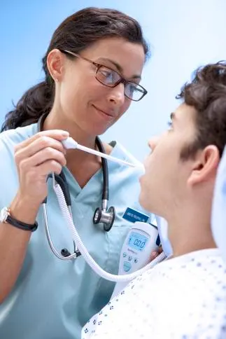 Healthcare profesional measurig patient temperature