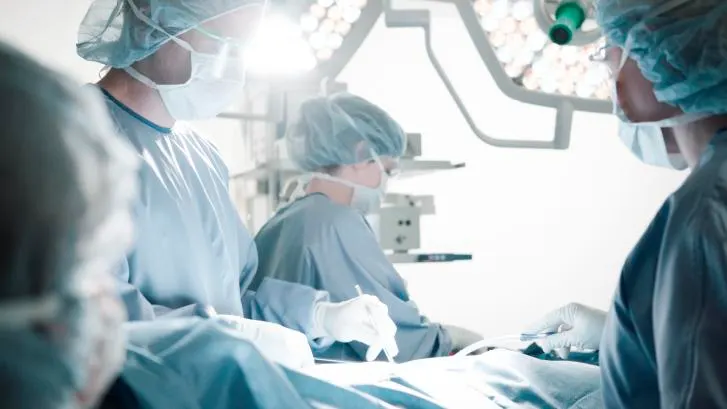 Surgeons operating on a patient.