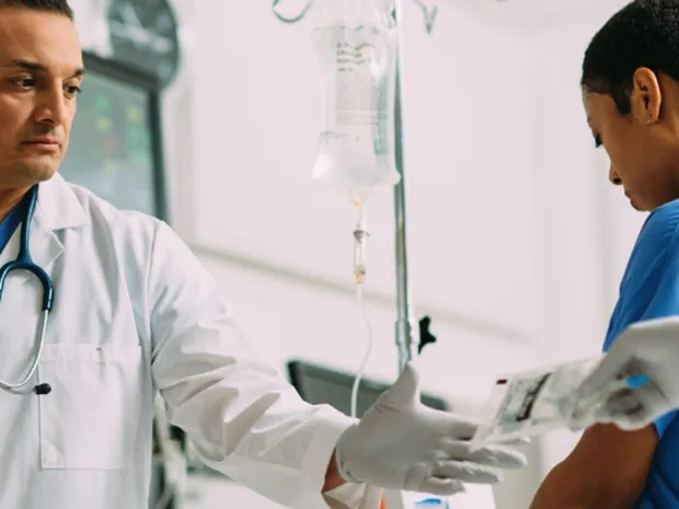 Physician being handed a premix injection bag