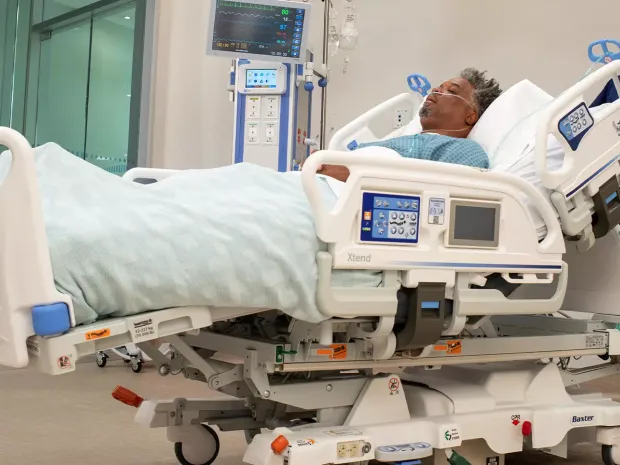 Male patient receiving care in a Progressa+ hospital bed