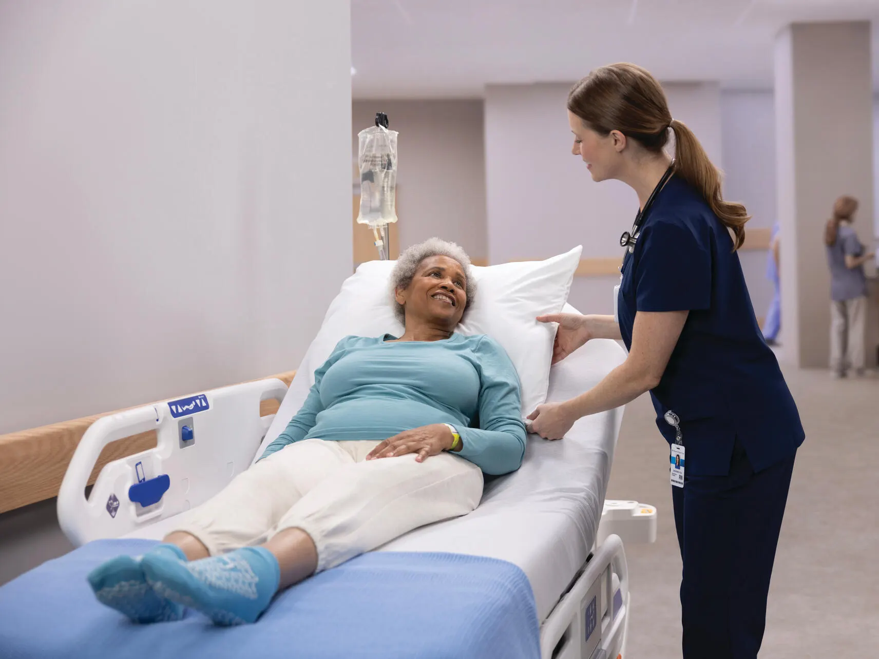 Healthcare profesional talking to a patient lying down on a Dynamo Strecher