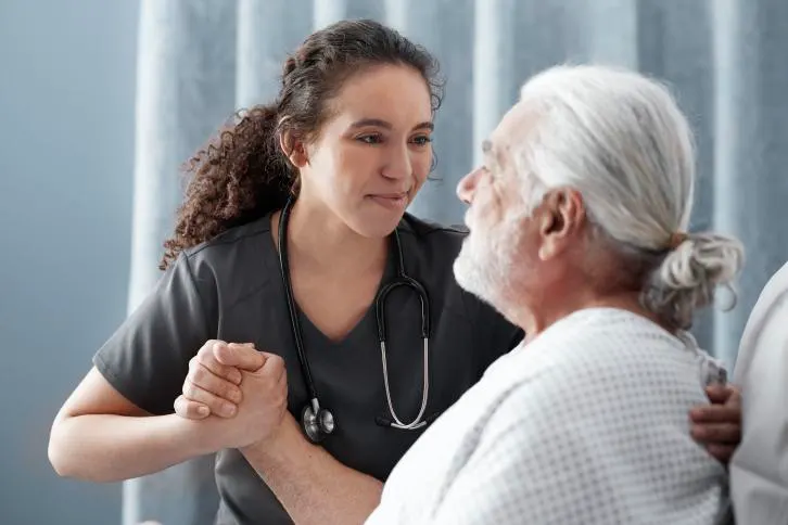 A healthcare worker smiles at a patient