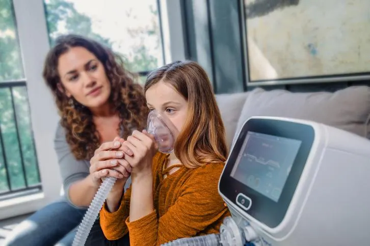 Volara System: OLE therapy for home care being utilized in the living room by a young woman