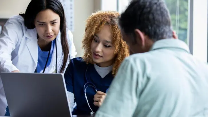Baxter employee working alongside caregivers
