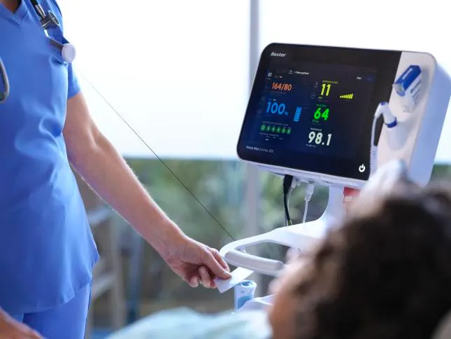 Healthcare worker using their ID badge to sign into the Connex Spot Monitor