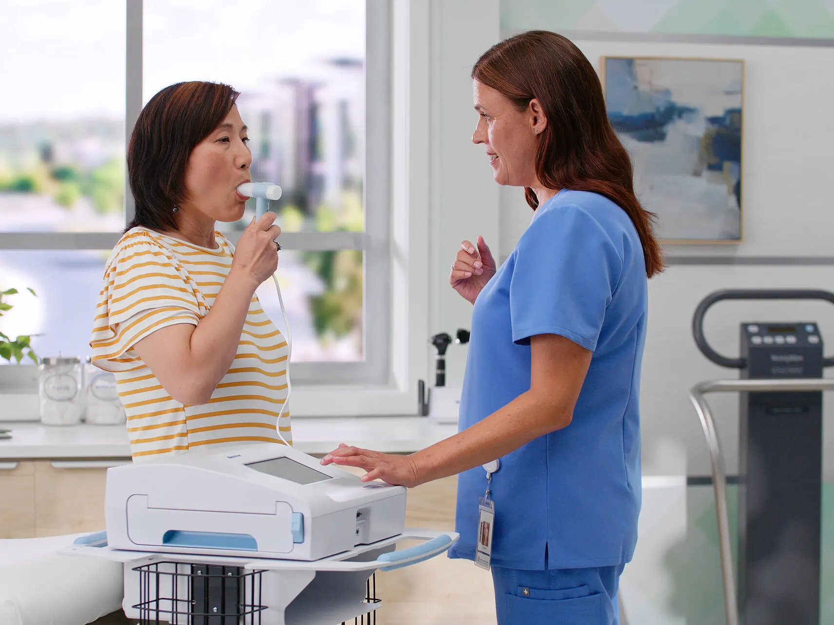 A cardiologist and patient conduct a test with the CP 150 Resting ECG