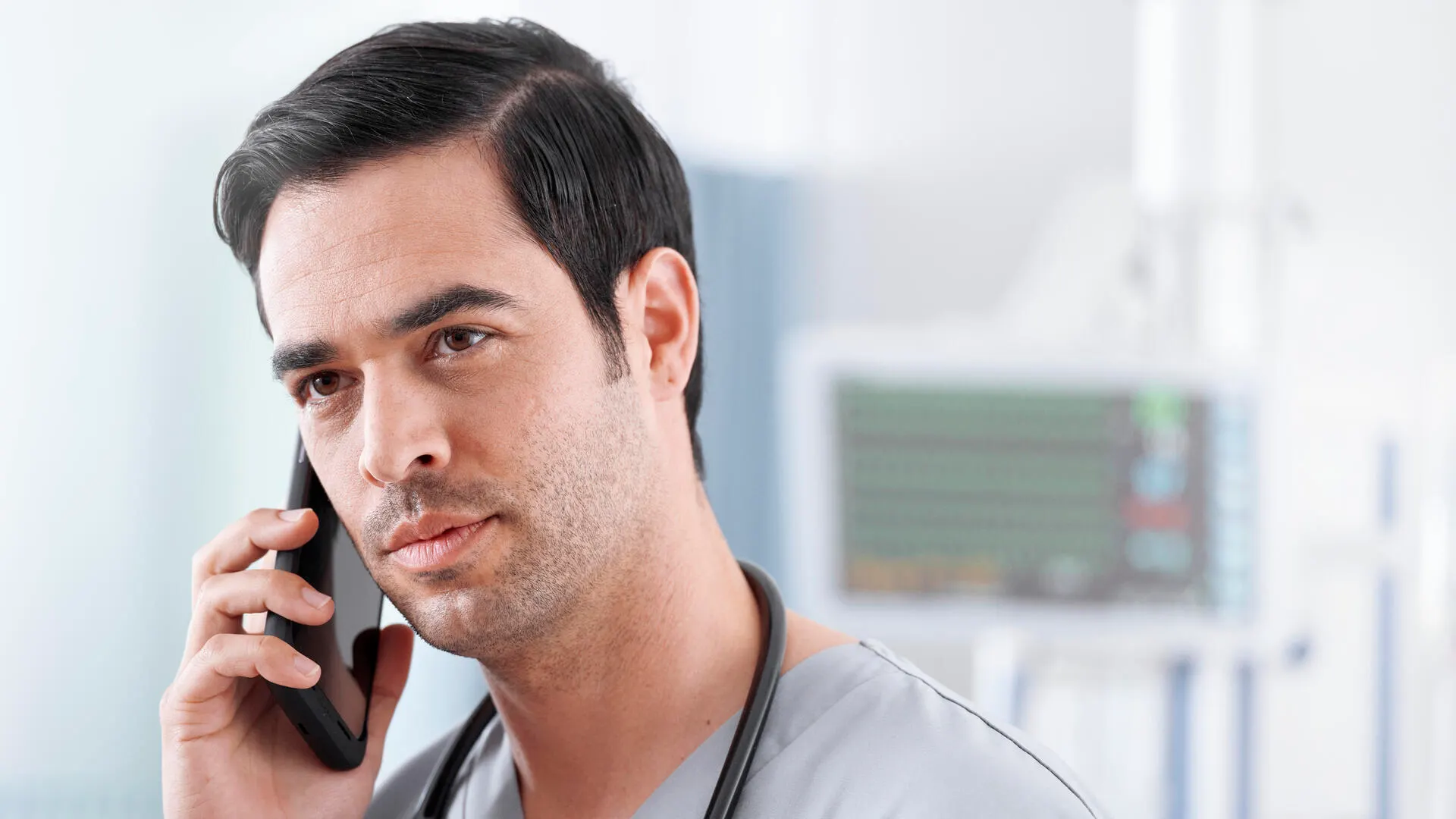 Healthcare worker in scrubs talks on the phone