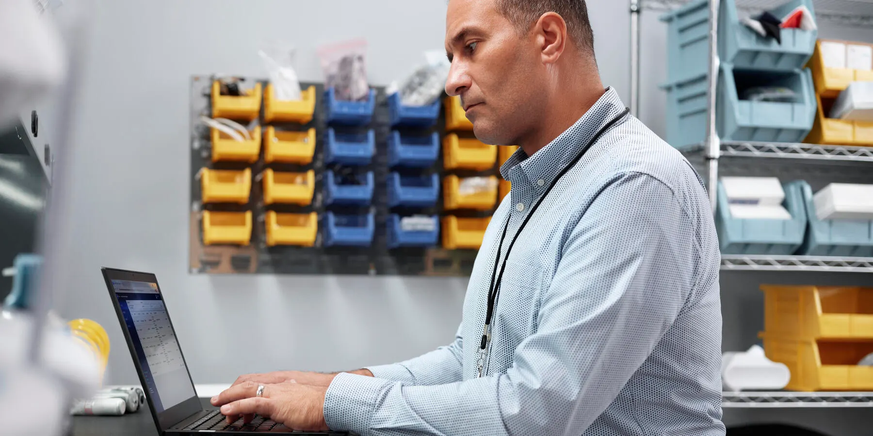 A remote service biomed technician works on his laptop