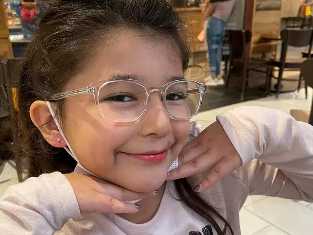 Avi poses for the camera in glasses