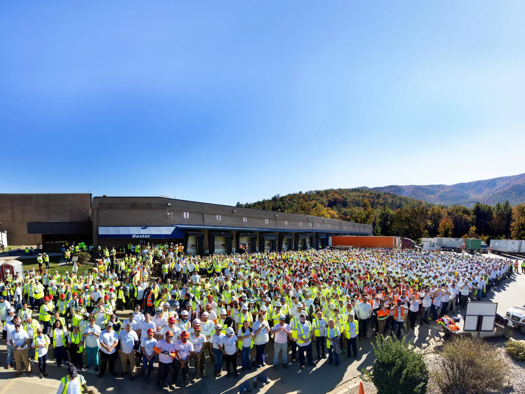 A group of baxter employees celebrate with blue balloons