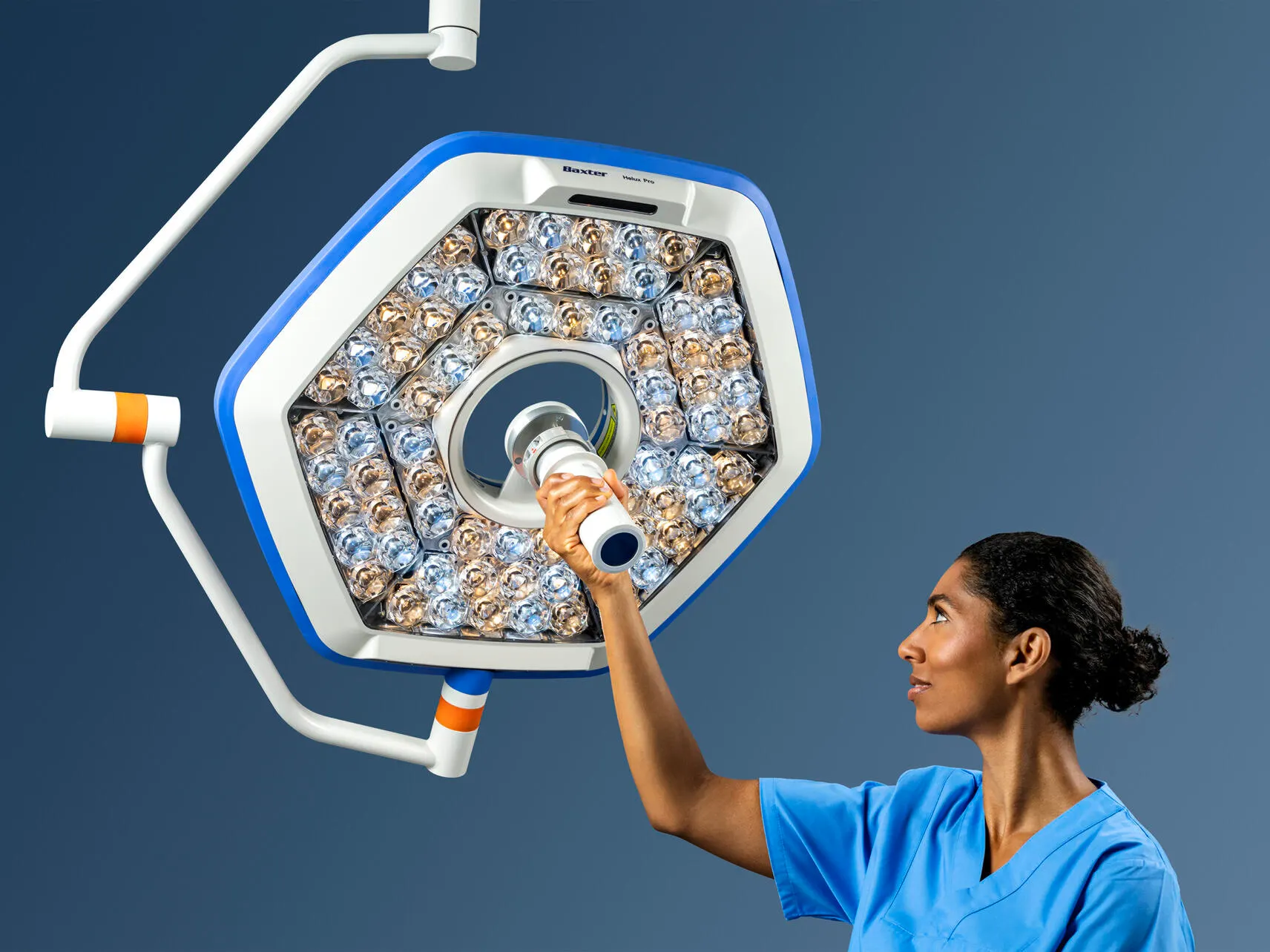 Clinician grasps sterile handle to adjust Helux Pro surgical light