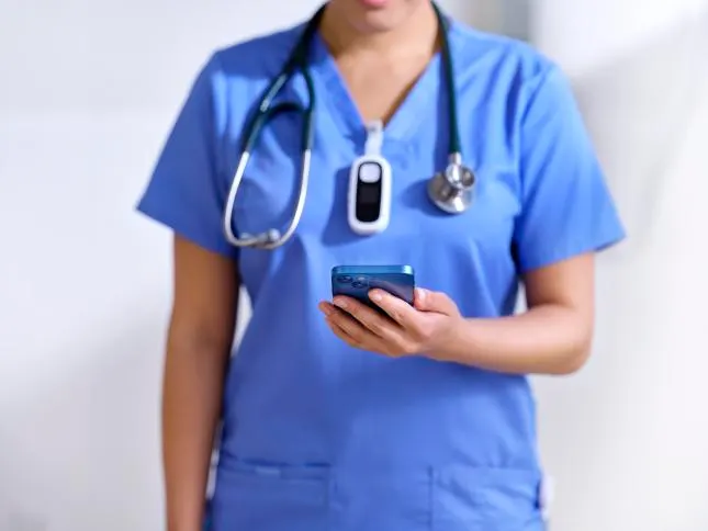 Nurse on Baxter Voalte device