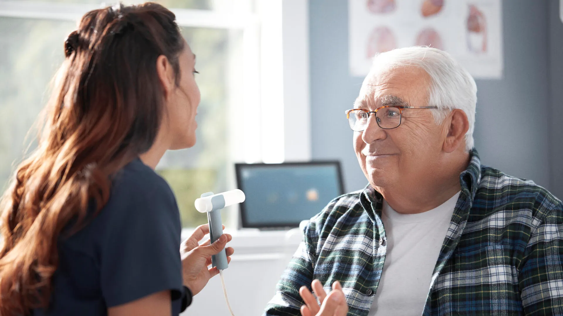 Technician shows patient a spirometry reader