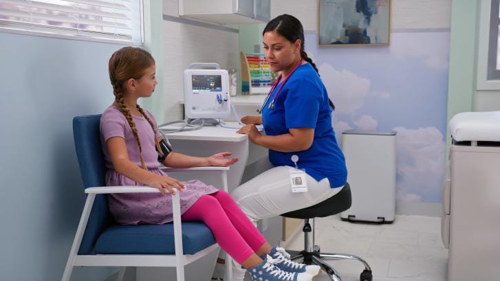 Pediatric patient getting vitals checked by nurse