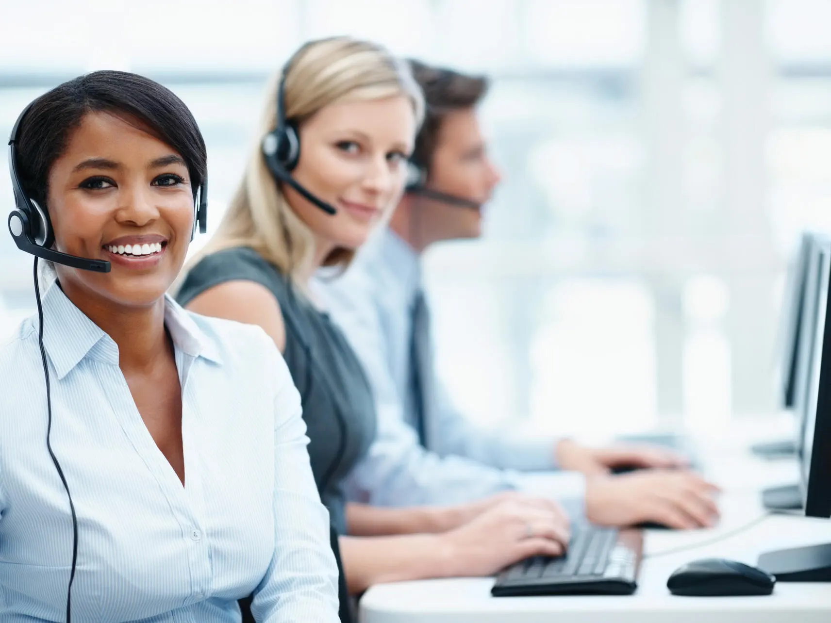 Call center workers smile at the camera