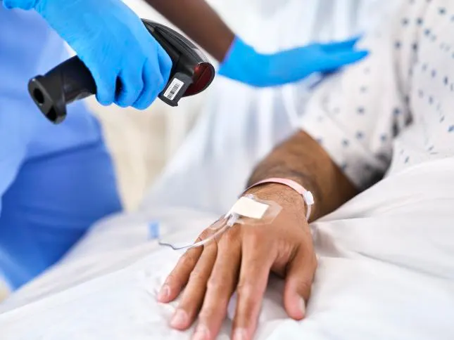 A Healthcare worker scans an infusion patient's barcode