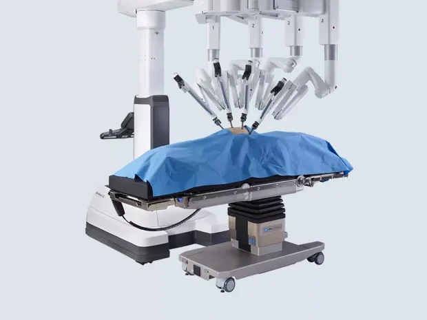 The TS7000dV Operating table with da Vinci Xi surgical system on a light grey background.