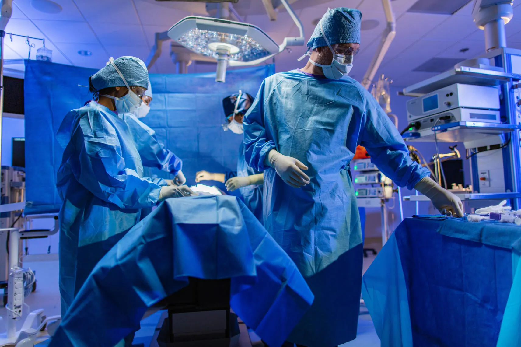 Surgeons in scrubs operating on a patient